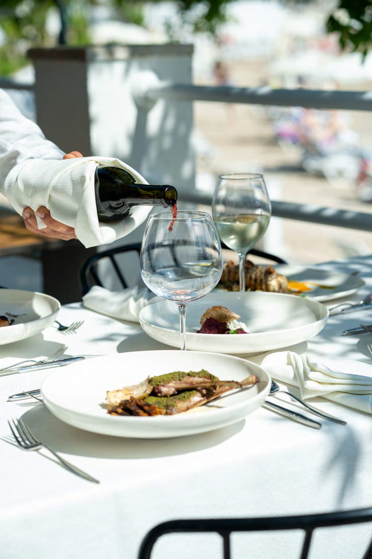 Wine being poured at an elegant al fresco dining table