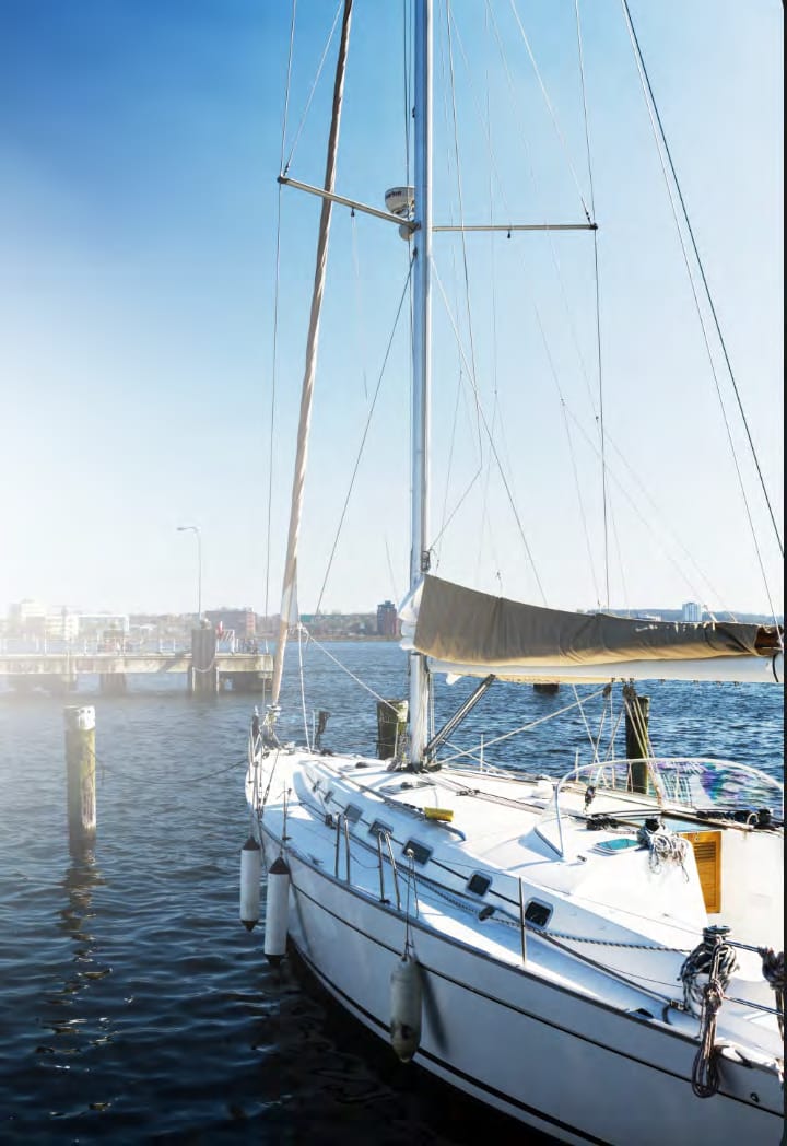 Sailing yacht moored at a sunny marina