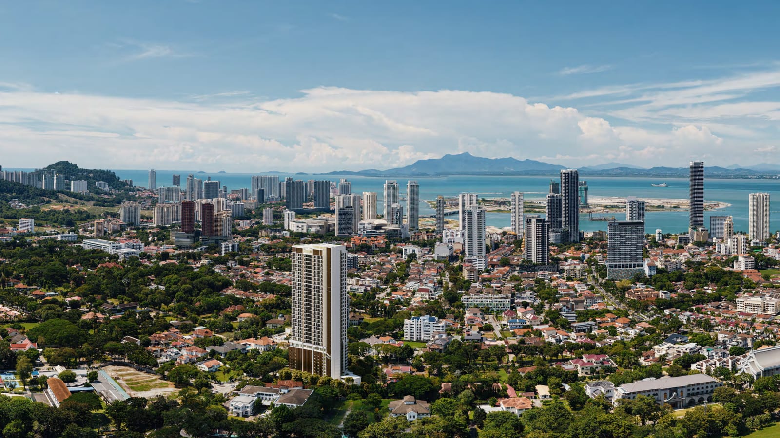 Aerial view of Cantonment Residence among low-rise homes and greenery, with Gurney and the sea beyond