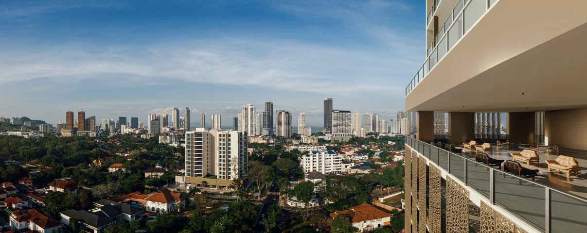 The Sky Lounge terrace with leather seating and a panoramic city and sea view